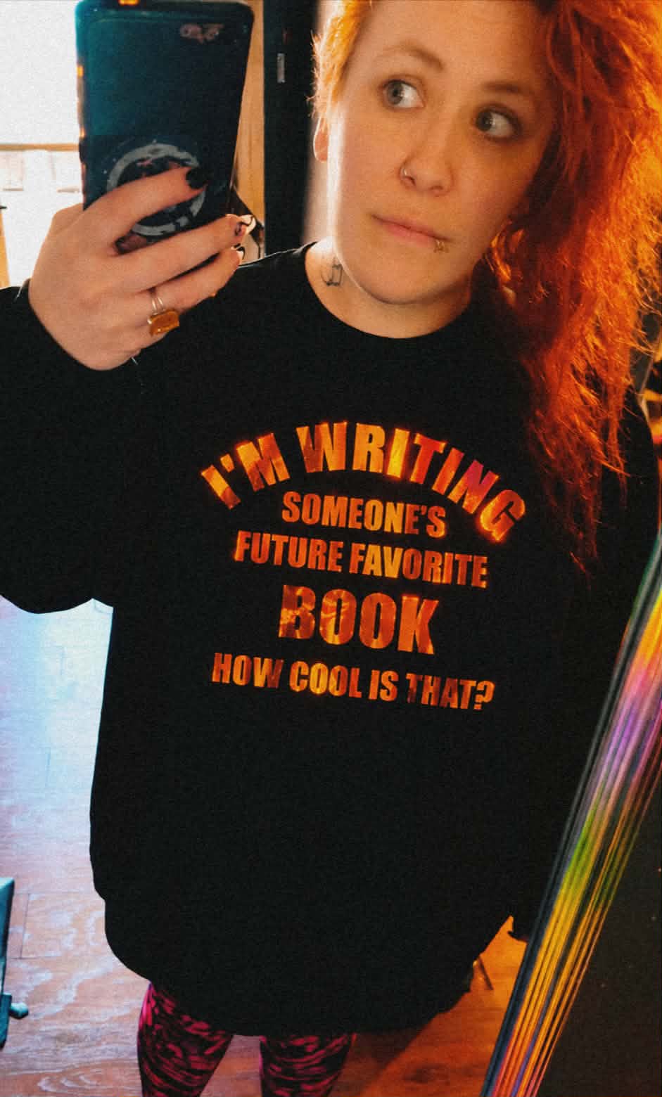 Aj Castelletto in a black hoodie that reads I'm writing someone's future favorite book